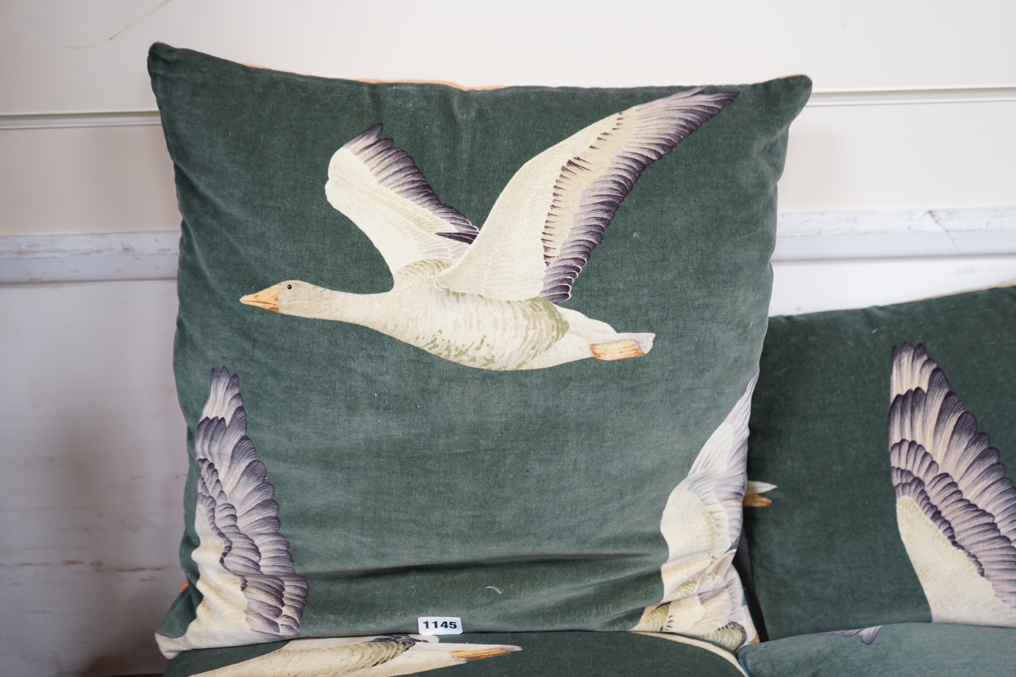 Two pairs of cushions decorated with geese